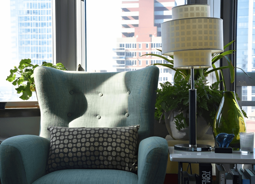 A living room with a chair and a lamp.